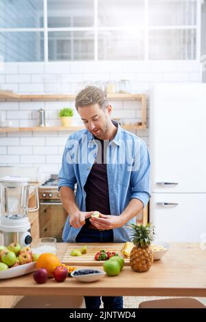 As healthy as it is tasty. a young man making a health smoothie at home. Stock Photo