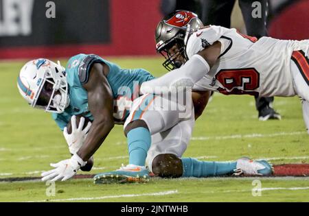 Tampa, United States. 13th Aug, 2022. Tampa Bay Buccaneers' Cam Gill (R) brings down Miami Dolphins' Trent Sheffield (L) during the first half of their preseason game at Raymond James Stadium in Tampa, Florida on Saturday, August 13, 2022. Photo by Steve Nesius/UPI Credit: UPI/Alamy Live News Stock Photo
