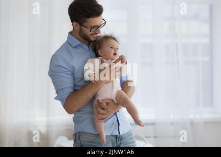 Young father holds on hands new born baby Stock Photo