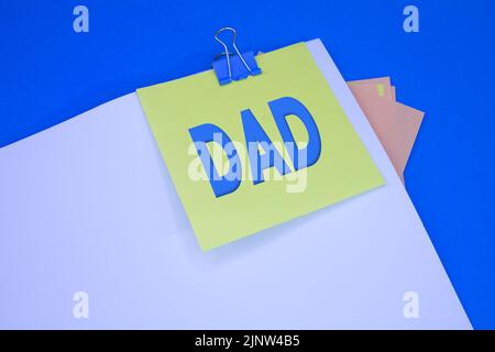 Dad. Text on adhesive note paper. Event, celebration reminder message. Stock Photo