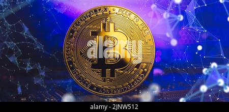 Bitcoins - the new modern currency for bitcoin payments ,  Golden Bitcoin Cryptocurrency on computer circuit board. Stock Photo