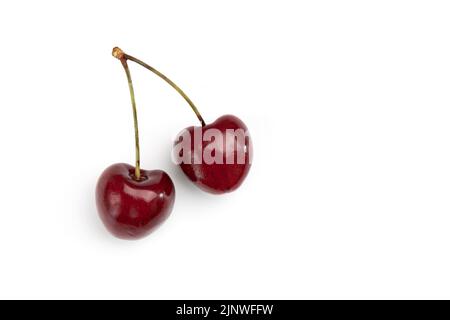 two ripe sweet cherries with empty space for text isolated on white background, group of red berries, top view Stock Photo