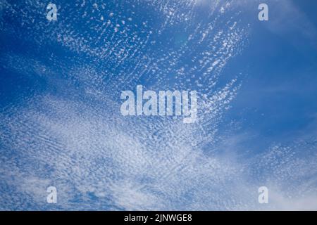 Bright and intense blue sky with white altocumulus clouds Stock Photo