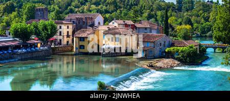 Borghetto sul Mincio - one of the most beautiful medieval villages of Italy. colorful houses located in the middle river and waterfalls. Verona provin Stock Photo