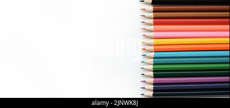 A set of colored pencils isolated on a white background in banner format. Place for text Stock Photo