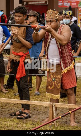 Central Kalamantan, Indonesia, May 20, 2022 - Men competing in blow gun competition. Stock Photo