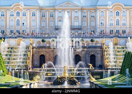 22 June 2022, Peterhof, Saint Petersburg, Russia. Grand Palace, Samson fountain and many tourists  in the lower park of Peterhof on a bright sunny day Stock Photo