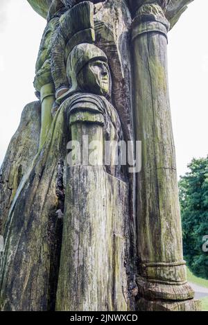 Wood carvings in tree trunks in the Pavilion Gardens in Buxton, Derbyshire, England Stock Photo