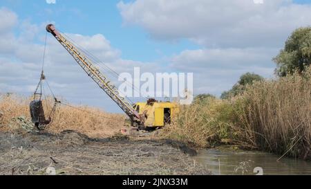 Excavator deepens and widens the canal between the Danube River and the lakes Stock Photo