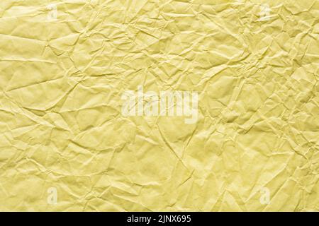 Crumpled paper texture in light yellow color. Clasic paper background. Stock Photo