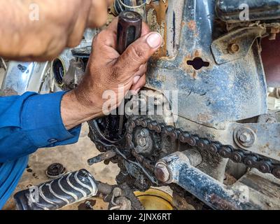 Working hands of a bike mechanic in the workshop Stock Photo