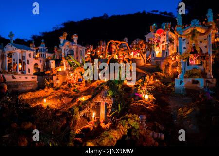 Tombs and graves are seen illuminated by burning candles during the Day of the Dead celebration at the cemetery in Xalpatláhuac, Guerrero, Mexico. Stock Photo