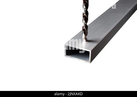 Drill in an aluminum steel profile tube isolated on white background. Making holes in metal. Metal drilling Isolated. Stock Photo