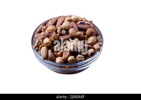 Assorted nuts in glass bowl isolated on white background. Mixed nuts for healthy diet isolated. Glass bowl filled by various nuts on white. Stock Photo
