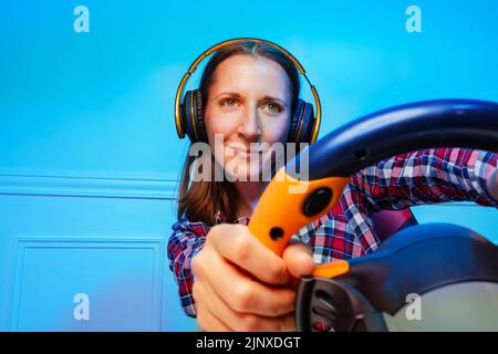 Portrait with console steering wheel of a gamer woman Stock Photo