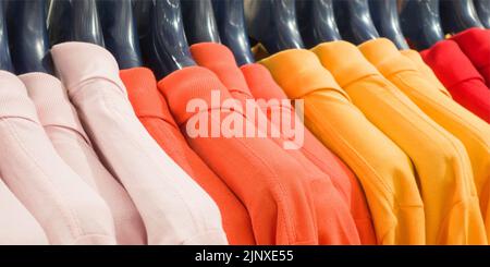 Photo of colorful clothes on hangers in shop Stock Photo