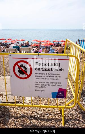 Brighton UK 14th August 2022 - A Do not BBQ on this Beach sign along Brighton seafront  as the heatwave weather continues in the South East but it is set to change with thunderstorms forecast for the next few days  : Credit Simon Dack / Alamy Live News Stock Photo