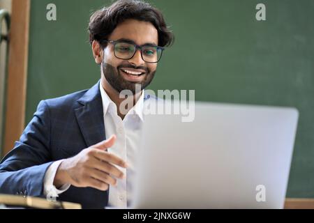 Indian business man manager, teacher having virtual meeting video call at work. Stock Photo