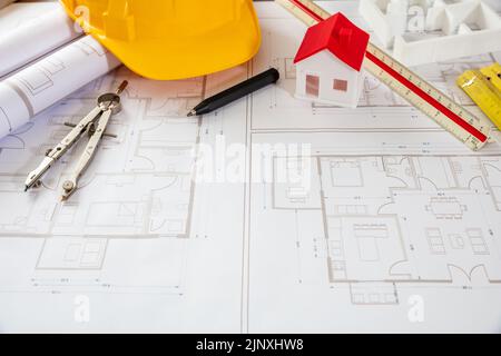Architect engineer office. Construction safety helmet and engineering tools on building blueprint plans, copy space Stock Photo