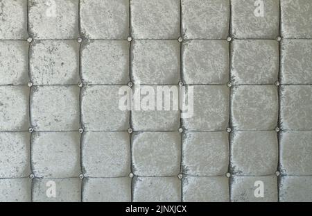 Gray silver soft fabric textile decorative background with buttons. Classic retro style, luxurious upholstery buttoned diamond crystal texture Stock Photo