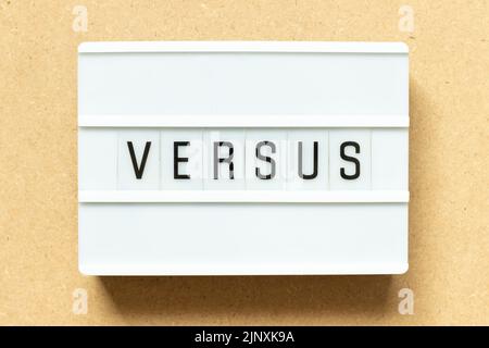 Lightbox with word versus on wood background Stock Photo