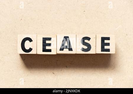 Alphabet letter block in word cease on wood background Stock Photo