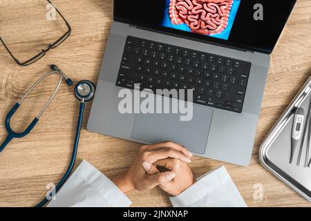 Top view of doctor showing a x-ray of stomach and intestine Stock Photo