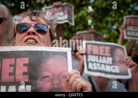 Manchester, UK. 14th Aug, 2022. People hold Free Julian Assange placards after the Peterloo march for democracy. Trade unions and local communities come together to show the government that the cost of living crisis is out of control and that the people will unite to fight back. Credit: Andy Barton/Alamy Live News Stock Photo