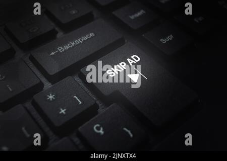Close up of computer keyboard with "Skip AD" text on button. Advertisement concept. Skip AD on video. Stock Photo