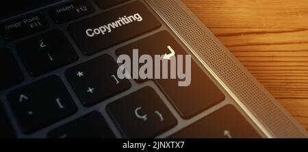 Banner close up of laptop keyboard with "copywriting" word on buttons and selective focus. Content writing or copywriting concept. Stock Photo