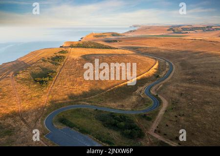 Stunning aerial drone landscape image of golden hour over farmers fields in South Downs National Park in England during Summer dawn Stock Photo