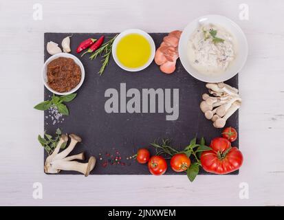 Fresh mediterranean cuisine ingredients on a black plate Stock Photo