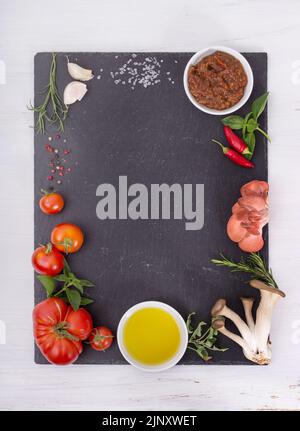 Fresh mediterranean cuisine ingredients on a black plate Stock Photo