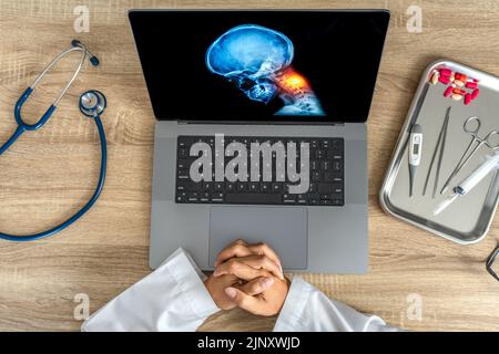 Top view of Doctor looking a x-ray of pain in the neck. Migraine Headache and backache.  Stock Photo