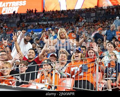 August 13, 2022, Denver, Colorado, USA: Denver Bronco fans celebrate during the 2nd. Half after the Broncos score their second TD at Empower Field at Mile High Saturday night. The Broncos beat the Cowboys 17-7. (Credit Image: © Hector Acevedo/ZUMA Press Wire) Stock Photo