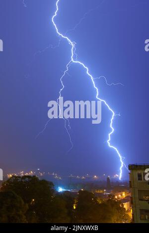 Storm Clouds and Lightning Bolts above the City Stock Photo