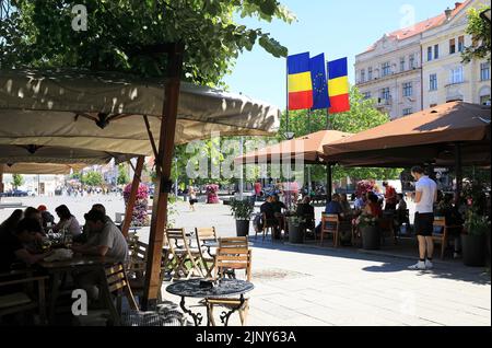 Pretty cafes on Piata Unirii, the Union Square in Cluj-Napoca, the historical capital of Transylvania, Romania Stock Photo