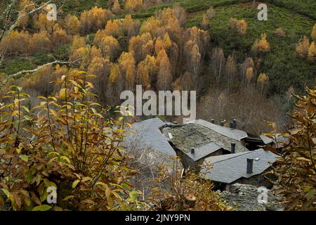 Small village in the mountain with traditional black slate roofs, autumnal rural scenery, Stock Photo
