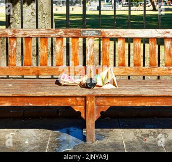 EDINBURGH CITY SCOTLAND ST ANDREWS SQUARE LITTER ON A SEAT ON A HOT DAY IN SUMMER Stock Photo
