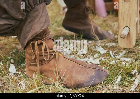 Retro photo. Leather boots of a carpenter working in the yard Stock Photo