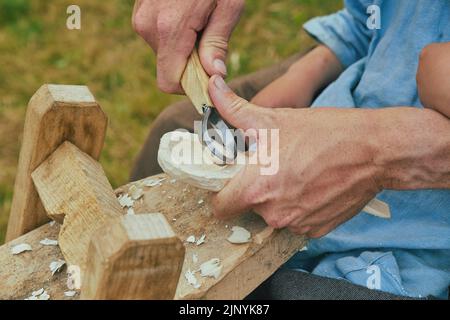 Retro photo. Carpenter carving a spoon close-up Stock Photo