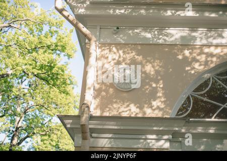 Shadows from trees on a plastered wall Stock Photo