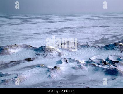 Frozen snow-covered sand dunes along the Lake Erie shoreline in February at the David M. Roderick Wildlife Preserve on State Game Lands 314 in Erie Co Stock Photo