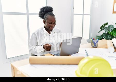 Young african american woman architect having video call at architecture studio Stock Photo