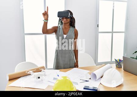 Young african american woman architect using virtual reality glasses at architecture studio Stock Photo