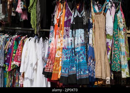 Colourful woman's dresses on a clothes rack, Cascais, Portugal. Stock Photo