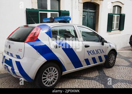 Parked police car on a city street in Cascais, Portugal. Stock Photo