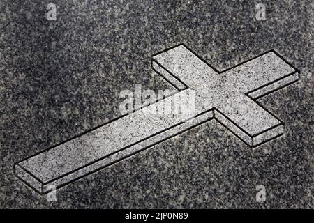 Religious Cross depicted on memorial monument in a cemetery. Stock Photo