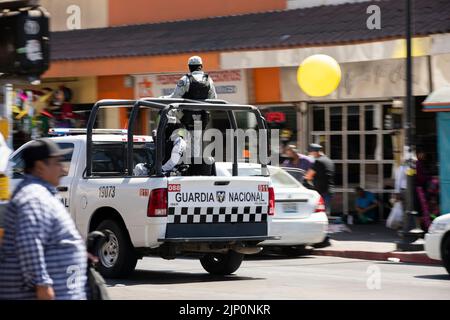 Tijuana, Baja California, Mexico - September 11, 2021: Motion panned view of a National Guard unit patrolling downtown Tijuana. Stock Photo