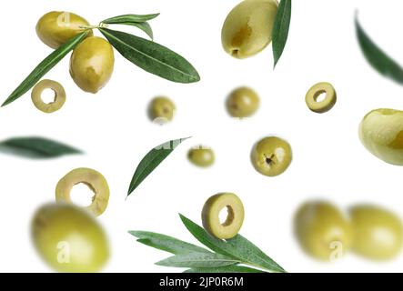 Falling green olives on white background Stock Photo